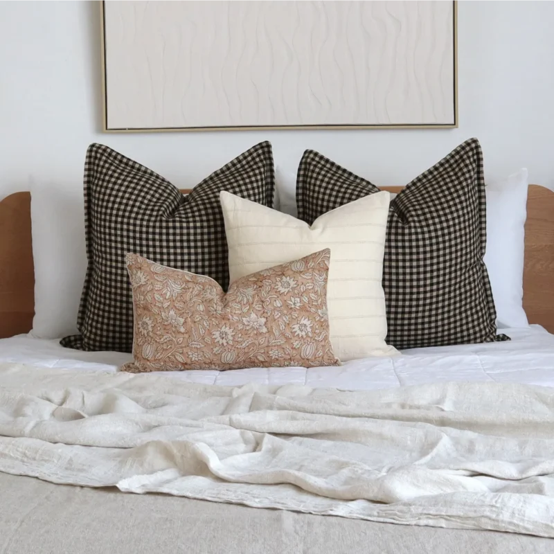 finn-bed-cushions-set-4-designer-covers-cola1150bb Four designer bed cushions add a pleasing look to the wooden bed.