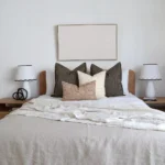 A framed wall art decoration hangs above the Finn designer set of 4 bed cushions.
