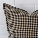 A macro image of the top left corner of this gingham designer cushion. It is possible to see the finer detail of the square shape.