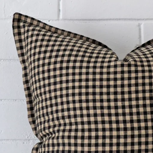 A macro image of the top left corner of this gingham designer cushion. It is possible to see the finer detail of the square shape.