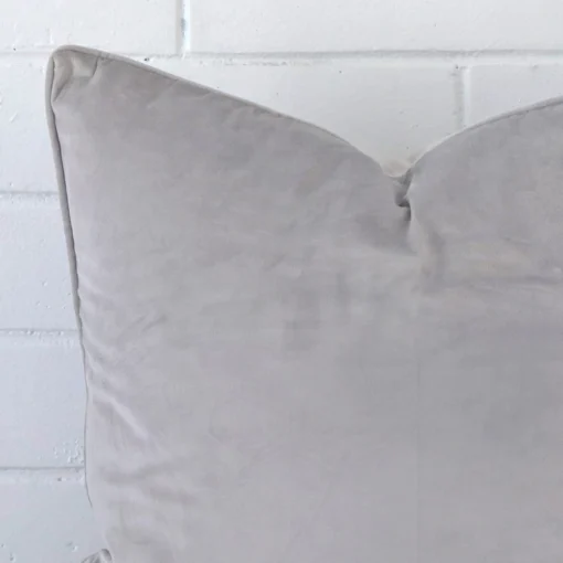 A detailed shot of this grey cushion cover that has velvet fabric and a square size.
