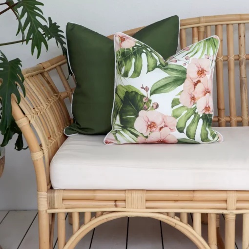 Olive outdoor sofa cushions including one with floral and leaf patterns match the green plants in the lounge.