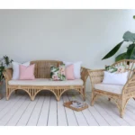 A floral pink sofa cushion chilling beside solid white and pink ones setting the vibe for your outdoor relaxation.