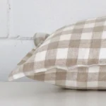 Side edge of gingham square cushion. The designer material can be seen from this lateral viewpoint.