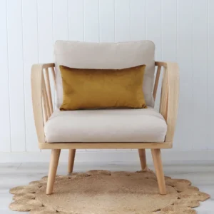 A gold cushion placed across a single chair with a wooden frame.
