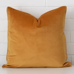 Front view of square cushion. Crafted from a special velvet material in a gold mustard colour.