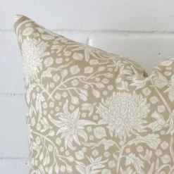 Focused view of floral square cushion cover. The shot shows details of its linen material and grey colour.
