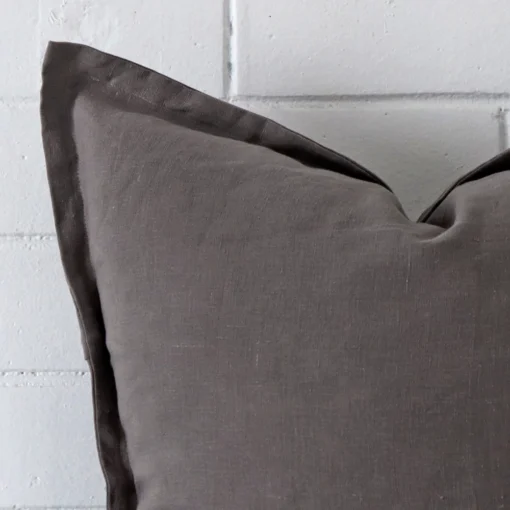 Magnified view of this linen grey cushion cover’s corner showing a square size.