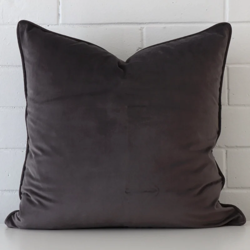 grey-velvet-cushion-cover-55cm-x-55cm-sc424-55b Bold square grey velvet cushion positioned in front of white brickwork.