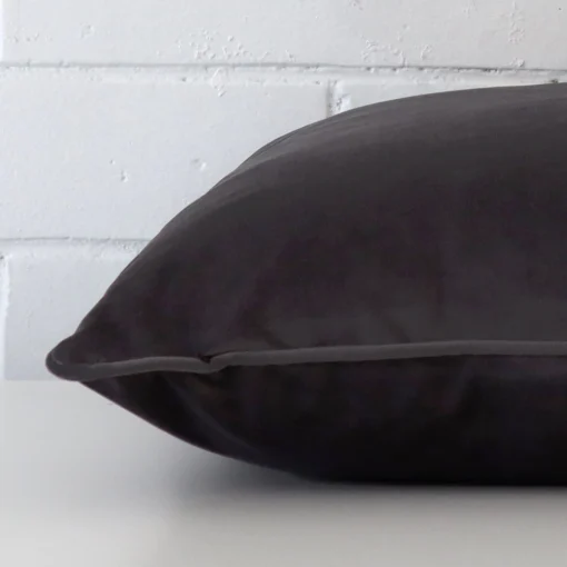 Lateral viewpoint of this velvet square cushion. The design and grey colour is shown from the side showing the front and rear panels.