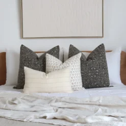 A white bedroom looks classy with the 4 designer bed cushions perfectly placed on a bed.