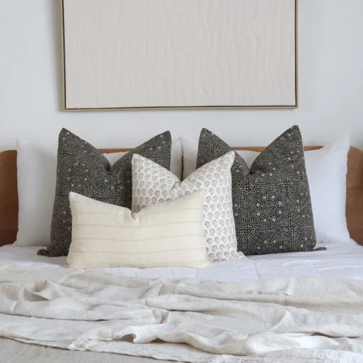 A white bedroom looks classy with the 4 designer bed cushions perfectly placed on a bed.