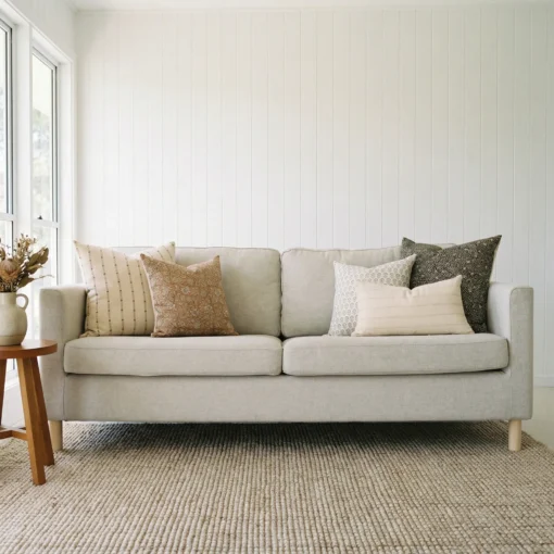 Hali cushions displayed on sofa with neutral tones and subtle geometric patterns.