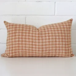 Rectangle gingham cushion cover in sitting upright in front of a brick wall. It has been made from a quality designer material.