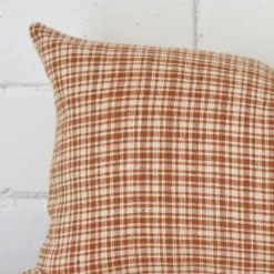 Cropped shot of top left corner of this gingham cushion cover. This viewpoint shows the designer fabric and rectangle shape with more precision.