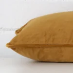 Rectangle velvet cushion cover positioned flat to show seams. The honey mustard hue and is shown between front and rear fabric panels.