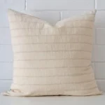 A premium designer cushion boasting a striped design and in a square size.