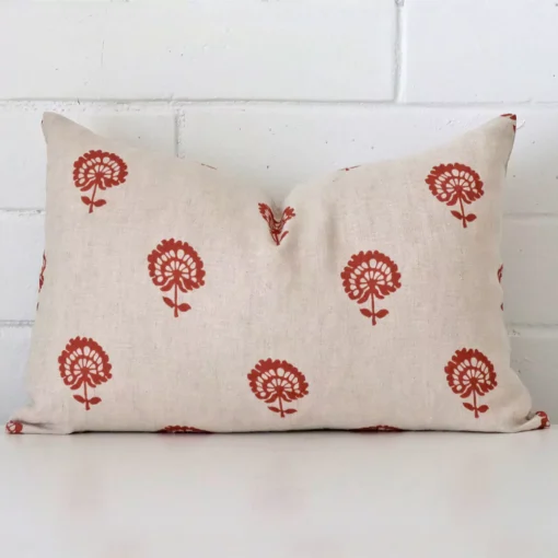 A gorgeous linen rectangle cushion in rust. It has an eye-catching floral design.