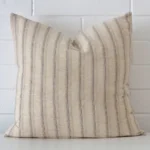 Front view of striped square cushion. Crafted from a special designer material.