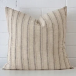 Front view of striped square cushion. Crafted from a special designer material.