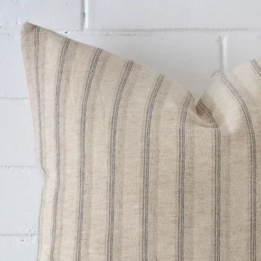 Zoomed in visual of designer square cushion cover. The intricacies of its striped design are visible.