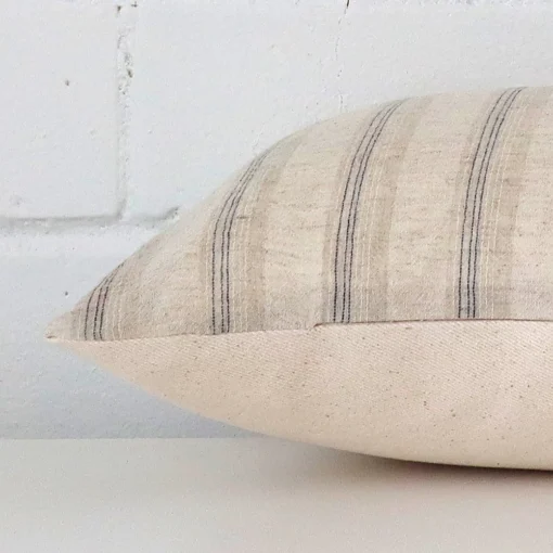 Side edge of striped rectangle cushion. The designer material can be seen from this lateral viewpoint