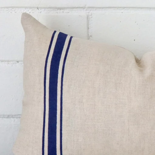 Very close photo of blue striped cushion. The shot shows the linen material and rectangle dimensions with more clarity.