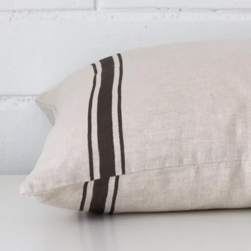 Lateral view of front and back panels of this striped linen cushion cover in a square size and with charcoal colouring.