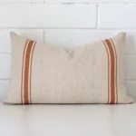 Gorgeous rectangle linen cushion cover that has a terracotta hue. It has a graceful striped design.