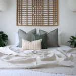The Jude designer set of 4 cushions is styled on a white bed.