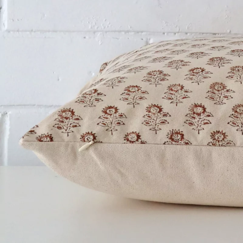 Square designer cushion cover positioned flat to show seams. It has a beautiful floral design.