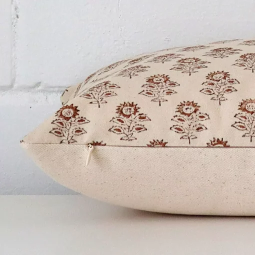 Side angle shot of designer rectangle cushion cover. The floral style is shown along its seams.