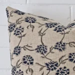 The corner of this designer square cushion cover is shown close up. The floral design is shown in greater detail.