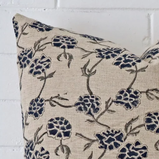 The corner of this designer square cushion cover is shown close up. The floral design is shown in greater detail.