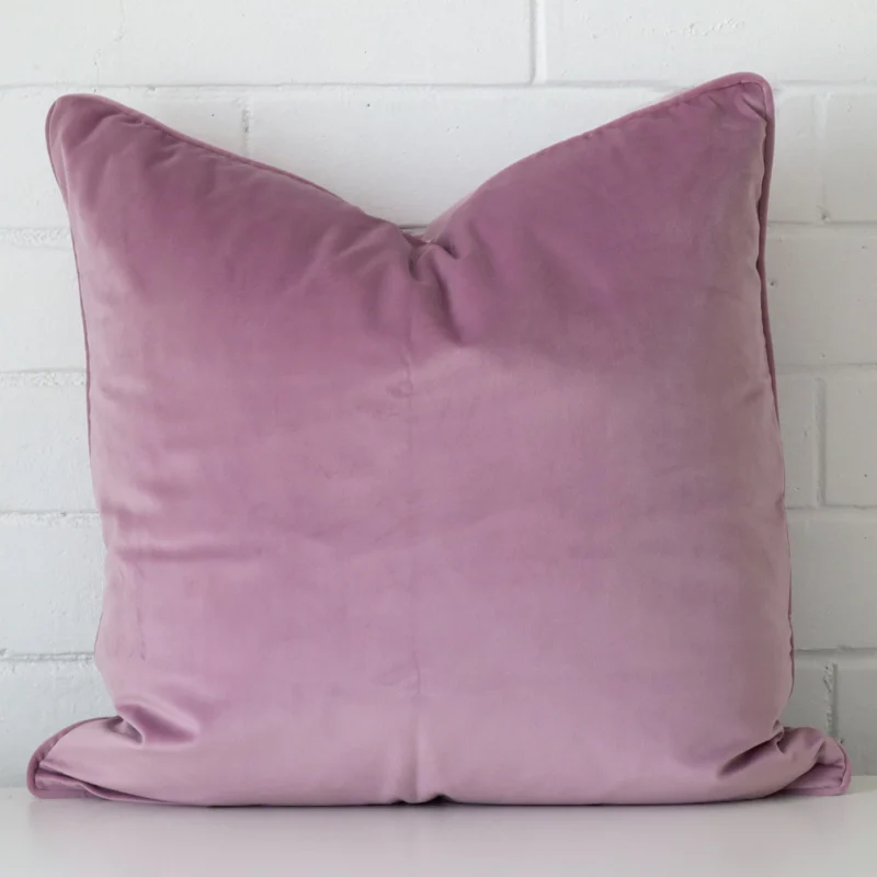 lavender-velvet-cushion-55cm-x-55cm-sc498-55b An attractive velvet cushion in front of a white brick wall. It has a square shape and is lavender in colour.