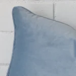 Focused view of Rectangle cushion cover. The shot shows details of its velvet material and light blue colour.