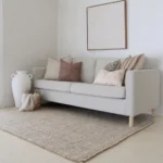 A light grey sofa's elegance is elevated by the Luka sofa cushions set, boasting five designer cushions.
