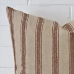 Cropped shot of top left corner of this striped cushion cover. This viewpoint shows the designer fabric and square shape with more precision.