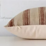 Lateral viewpoint of this designer rectangle cushion. The striped design is shown from the side showing the front and rear panels