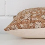A sideways perspective of this floral designer cushion. The positioning shows the border of the rectangle shape.