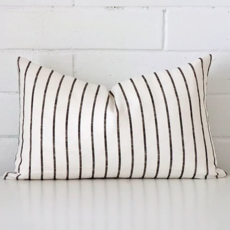 maya-linen-striped-cushion-cover-rectangle-sc1000-30 Striped cushion cover in front of a white wall. It has a rectangle size and is made from a linen material.