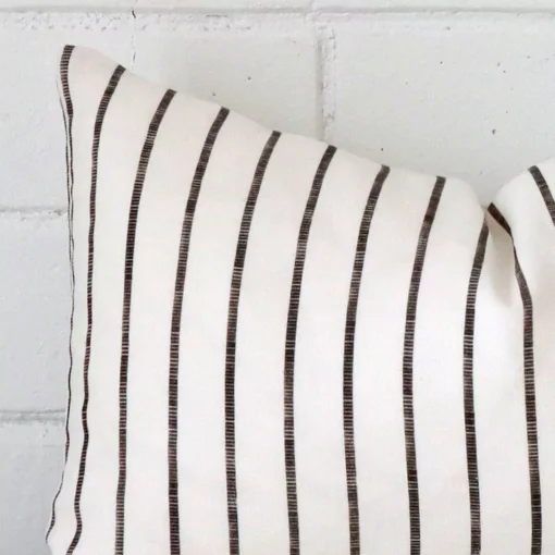 Close range image of striped cushion. The rectangle size and linen material can be seen in detail.