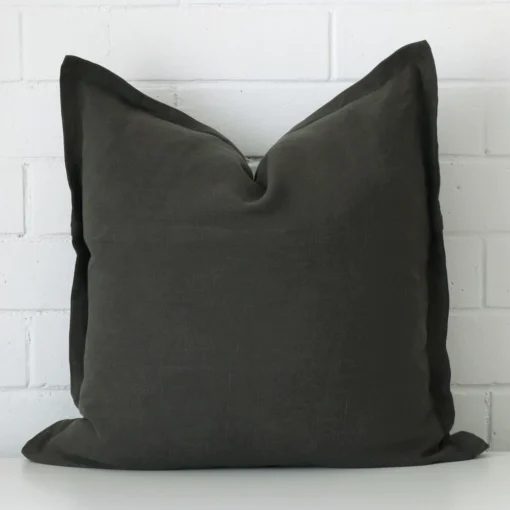 A premium linen moss green cushion in a square size.