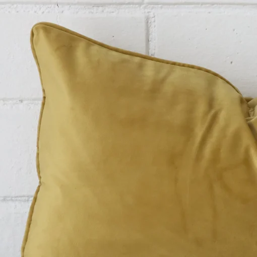 Zoomed in visual of velvet rectangle cushion cover in mustard.