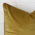 Magnified view of this velvet mustard cushion cover’s corner. It has a square design.