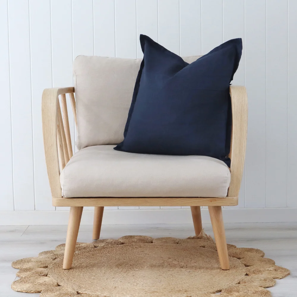 A navy cushion styled on a single chair.