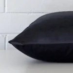 The edge of this velvet large cushion in navy is shown.