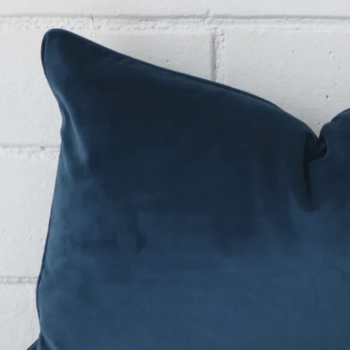 A detailed shot of this navy cushion cover that has velvet fabric and a rectangle size.