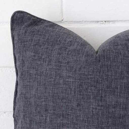 Close up image of linen square cushion. The image allows you to see the charcoal hue more thoroughly.