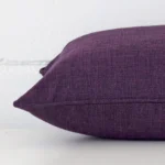 Close side shot of this plum linen cushion cover. It has a rectangle design.